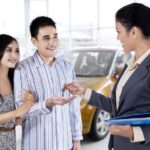 Customer receiving keys at a Toyota dealership