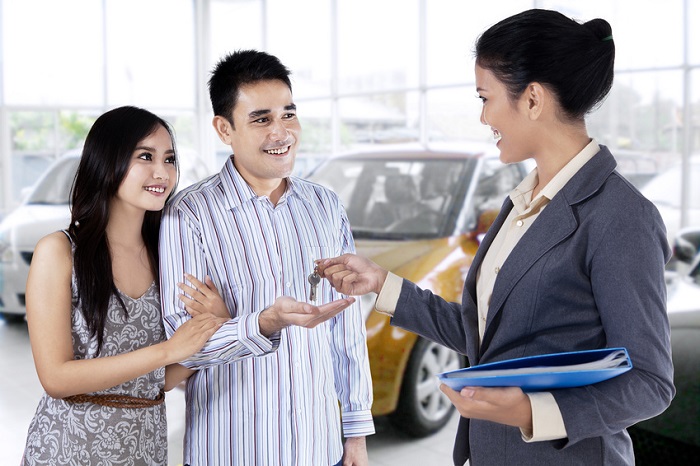 Customer receiving keys at a Toyota dealership